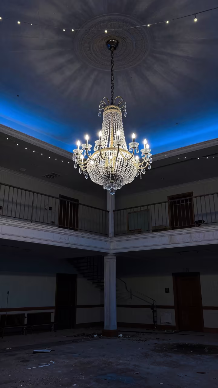 Abandoned Hotel Lobby Chandelier Evening Blue Light in inside a collapsed lobby under broken plaster in Arkansas