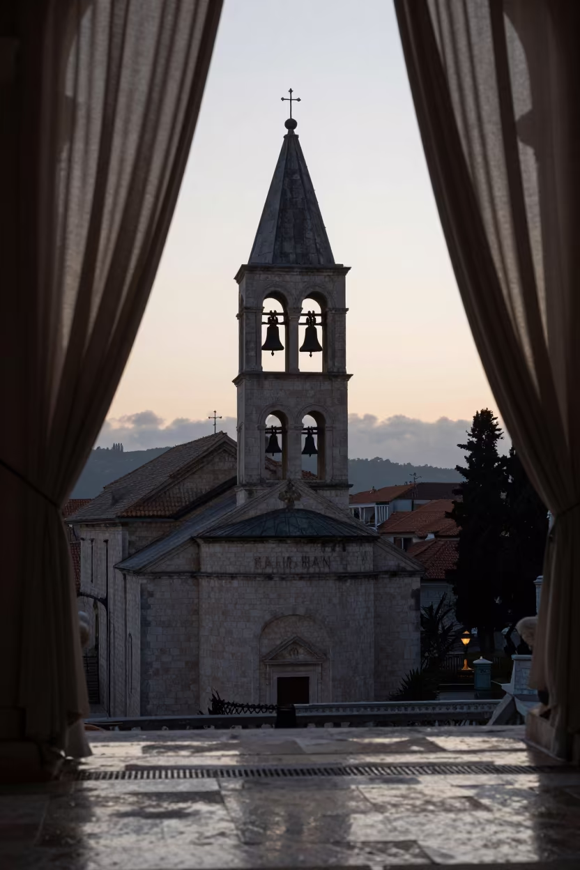 Abbey Bell Tower Silhouette Dawn Light in inside a stone chapel in Budva