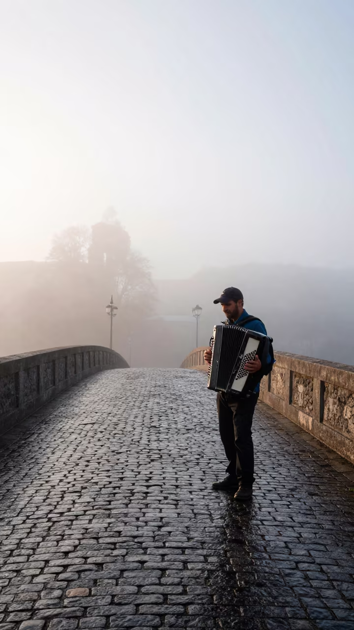 Accordion Musician on Misty Cobblestone Bridge in near Belas