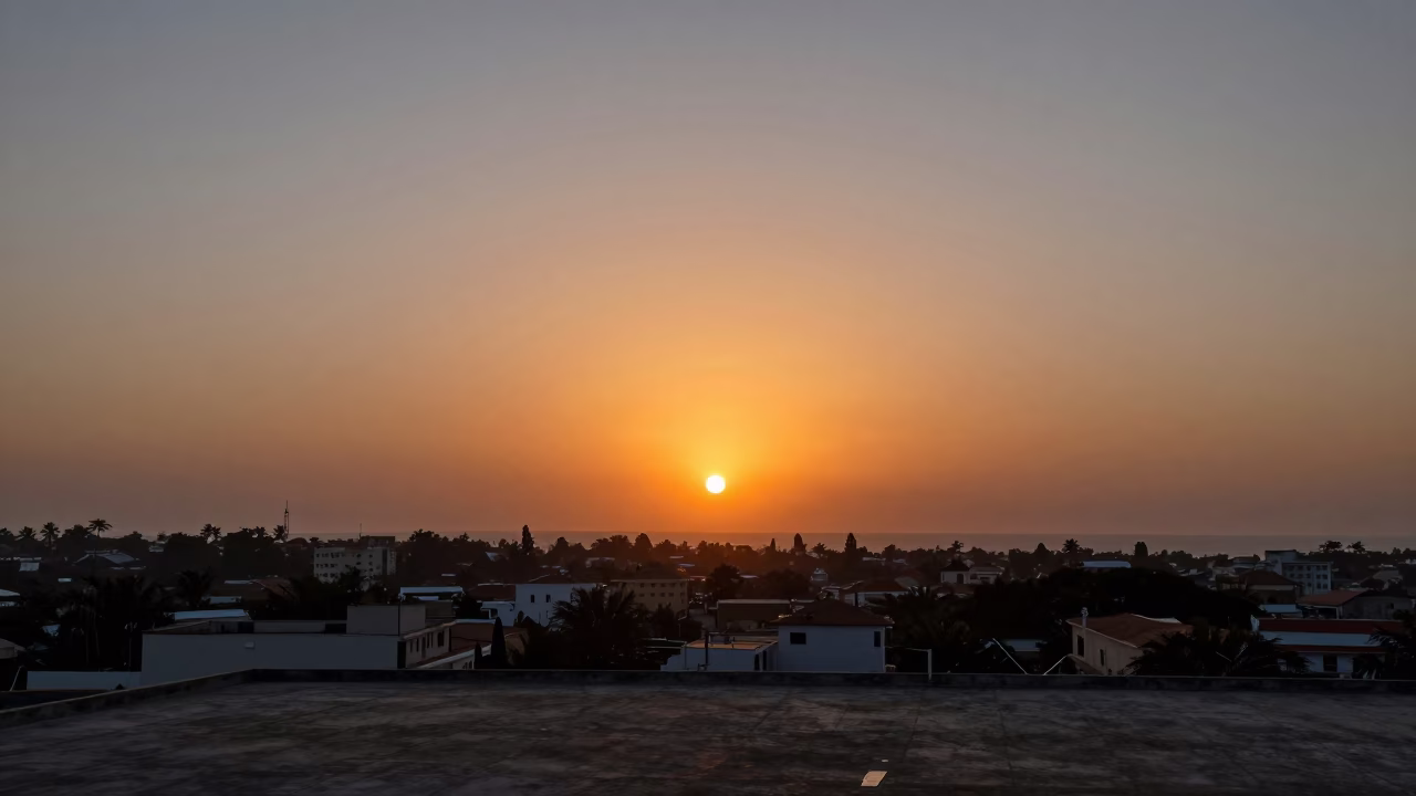 Accra Ghana Sunset Horizon View Over Urban Rooftops and Coastal Distant Skyline in in Accra, Ghana