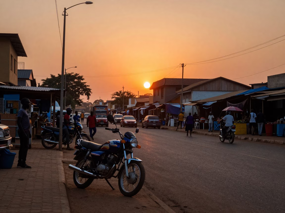 Accra Ghana Sunset Street Scene with Motorcycle and Local Market Activity in in Accra, Ghana