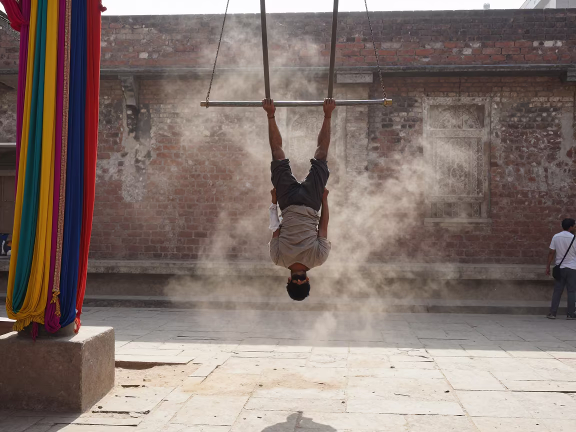 Acrobat Hanging from Trapeze at Nizamabad Street Corner in at a street corner busking spot in Nizamabad
