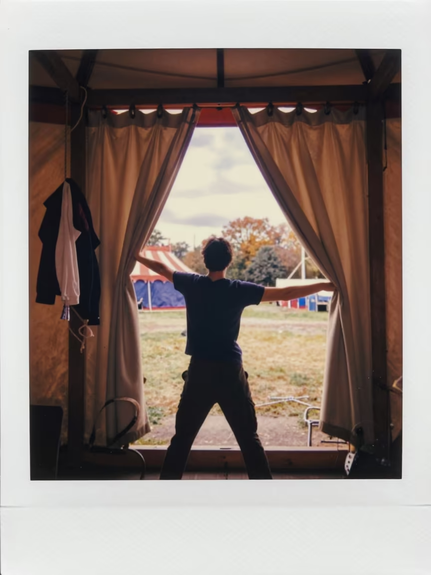 Acrobat Stretching Behind Circus Tent Curtain in under a circus tent in Toulouse