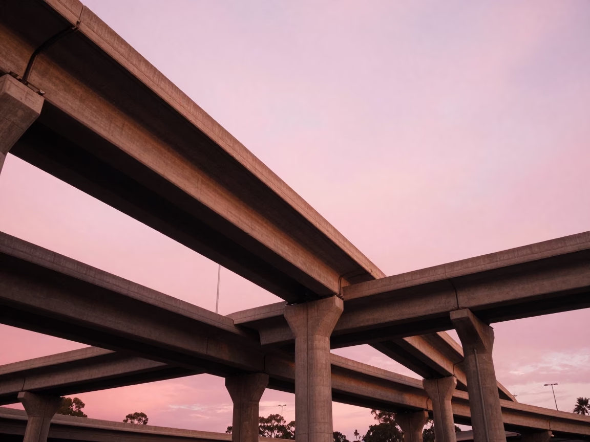 Adelaide highway flyover stack cutting across pink evening sky in honeyed light in in Adelaide, South Australia, Australia