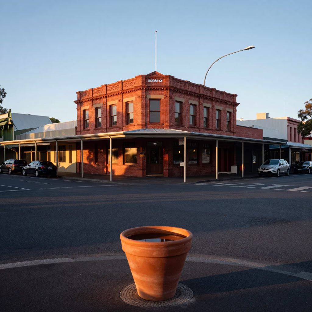 Adelaide sunrise street scene with terracotta pot and water rings on wooden table in in Adelaide, South Australia, Australia
