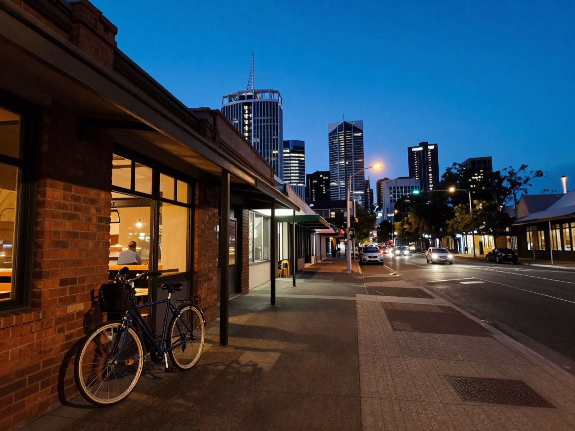 Adelaide twilight street scene with bicycle leaning against cafe and urban skyline in in Adelaide, South Australia, Australia
