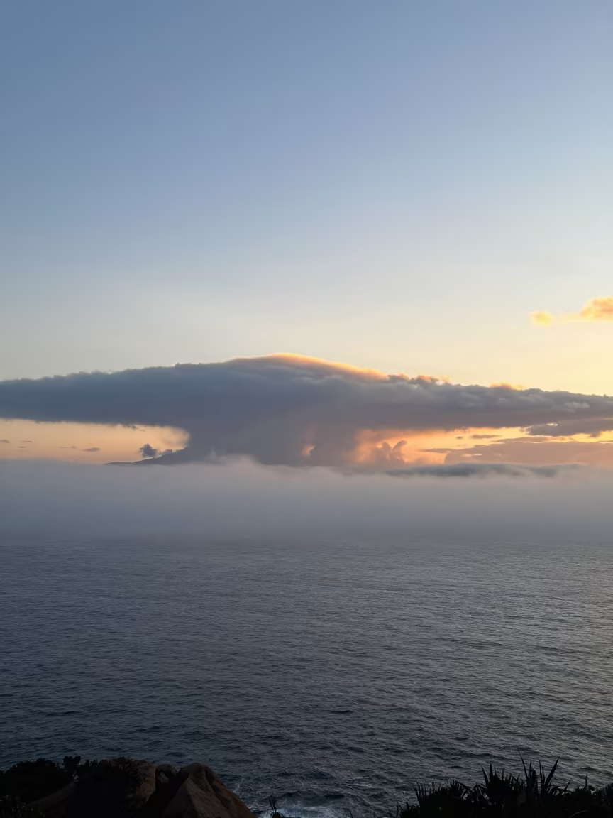 Advection Fog Rolling Over Sardinia Winter Ocean in over a horizon of stacked thunderheads in Sardinia