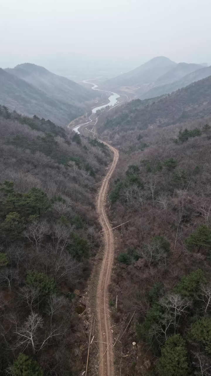 Aerial Avalanche Path Through Late Spring Forest in far above river meanders near Tianjin