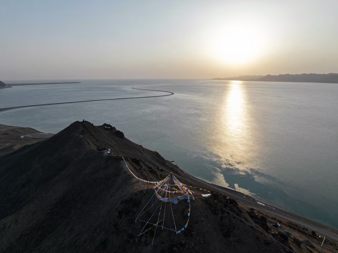 Aerial Barrier Reef View Low Sun Horizon in on a wind-cut ridge below prayer flag lines near Lhasa