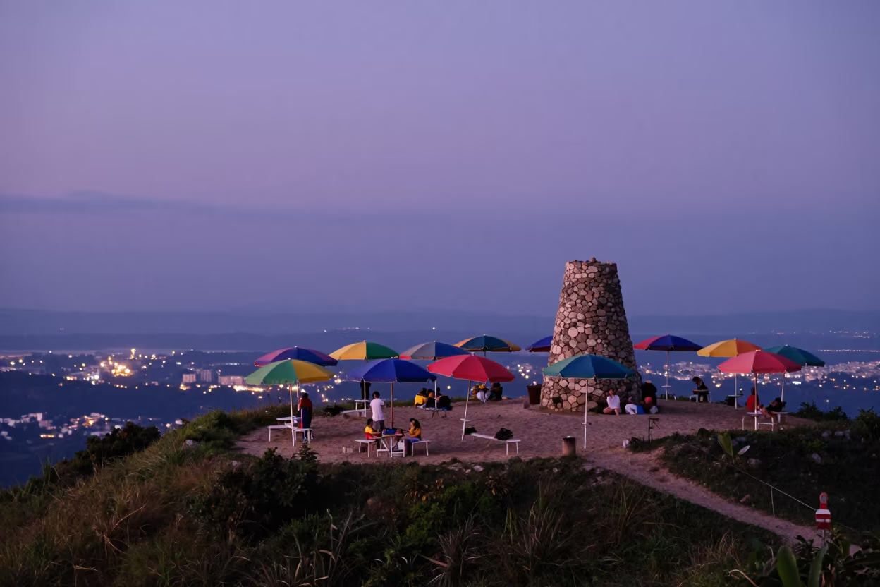 Aerial view of beach umbrellas beside summit cairn in beside a summit cairn above the tree line near Shimla