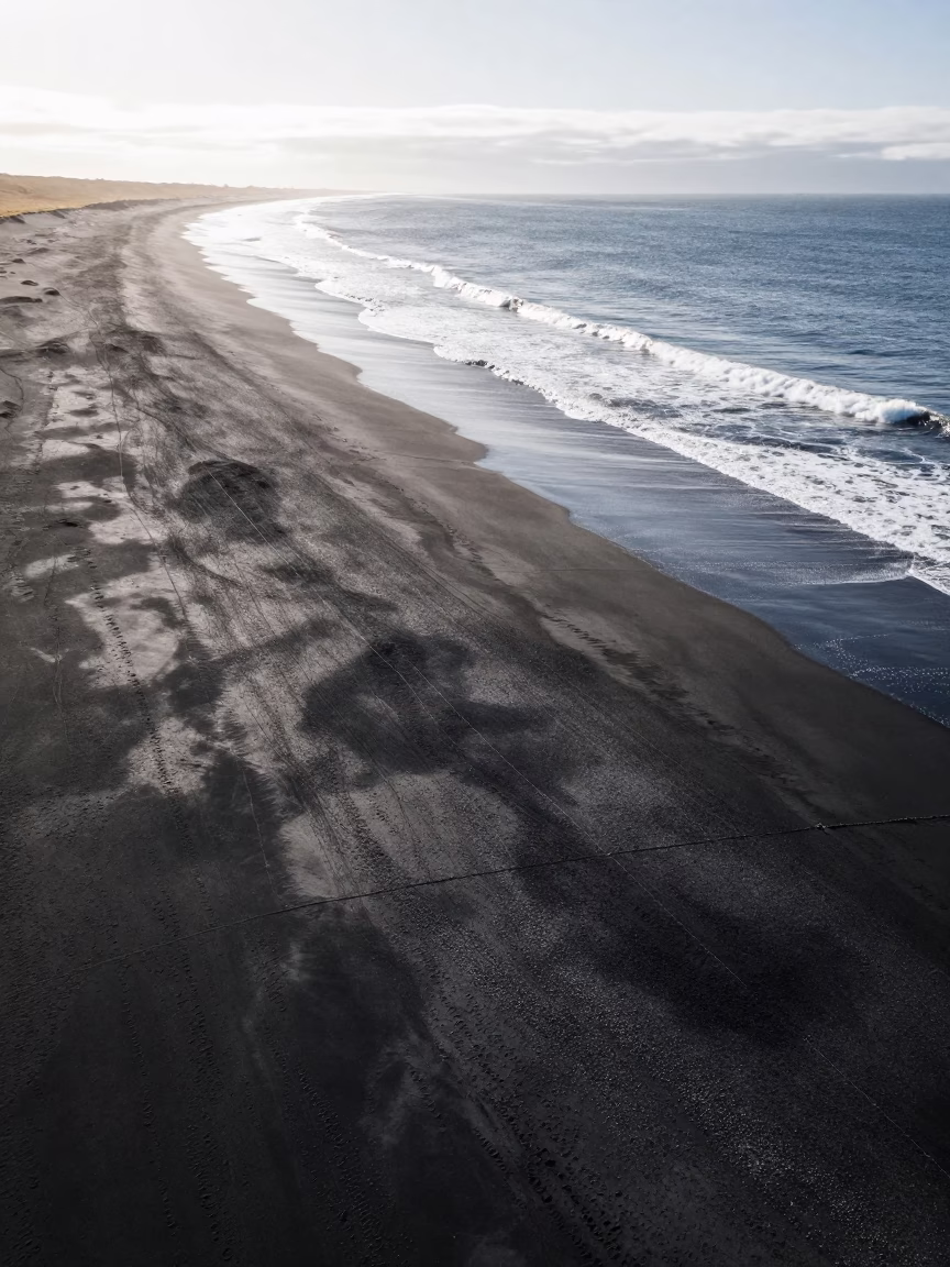 Aerial Black Sand Beach White Surf Iceland in high above irrigation geometry in Iceland