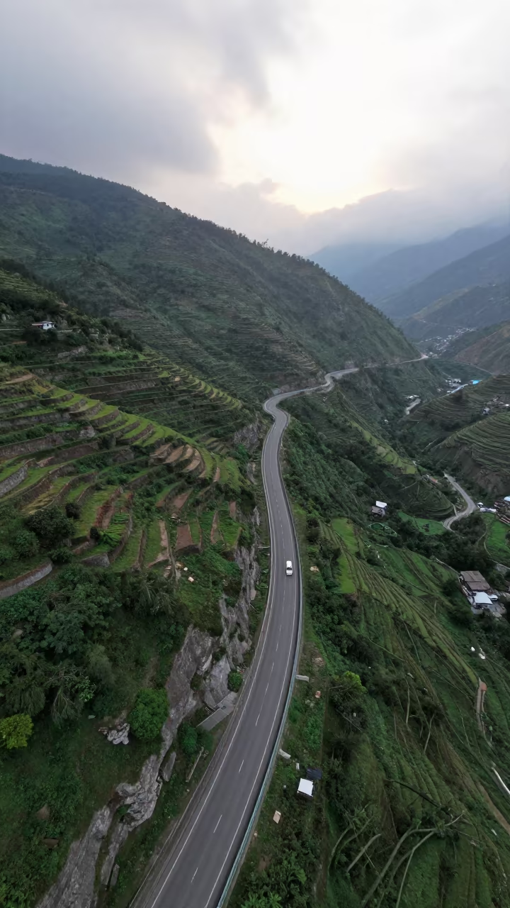 Aerial Coastal Highway Cliffside Uttarakhand Pre dawn in far above terraced hillsides in Uttarakhand