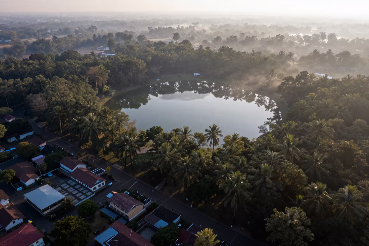 Aerial Dawn Over Forest Lake and Bhiwandi Rooftops in high above patterned rooftops near Bhiwandi