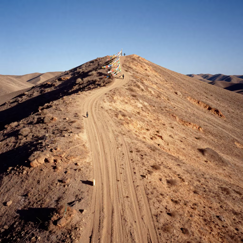 Aerial desert ridge tracks near Thimphu prayer flags in on a wind-cut ridge below prayer flag lines near Thimphu