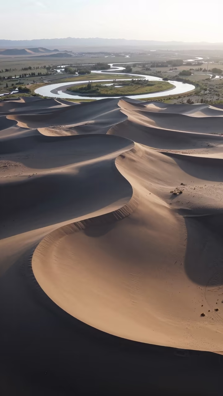Aerial Mongolian Dunes Dawn Shadows in far above river meanders in Mongolia