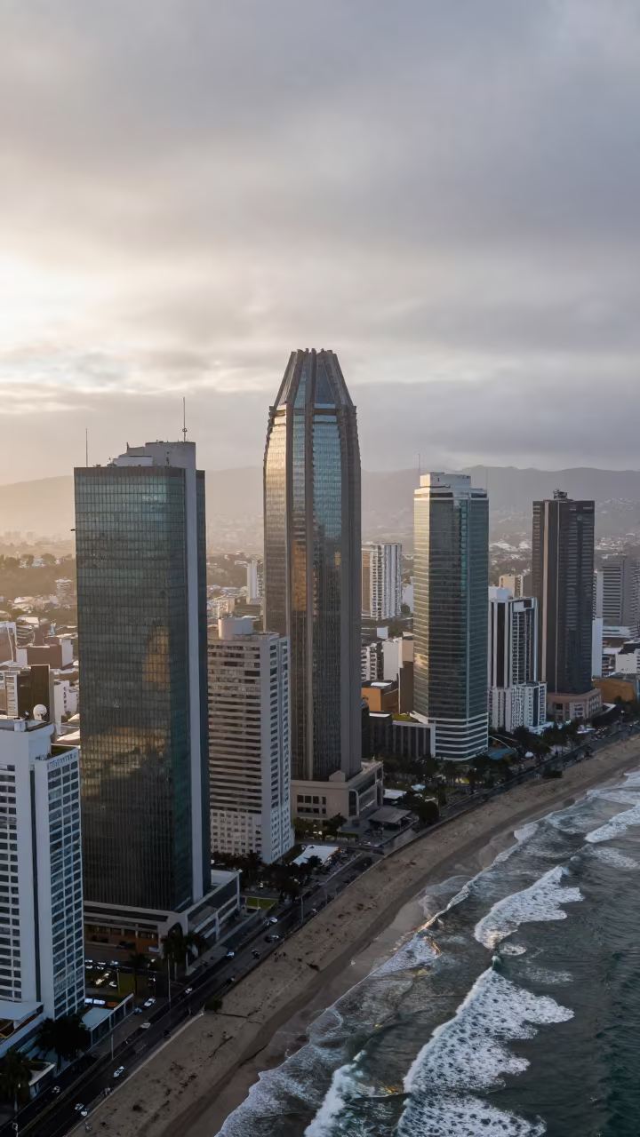 Aerial Morning Skyscrapers Rain Coast in far above surf-scalloped coastline near Ensenada
