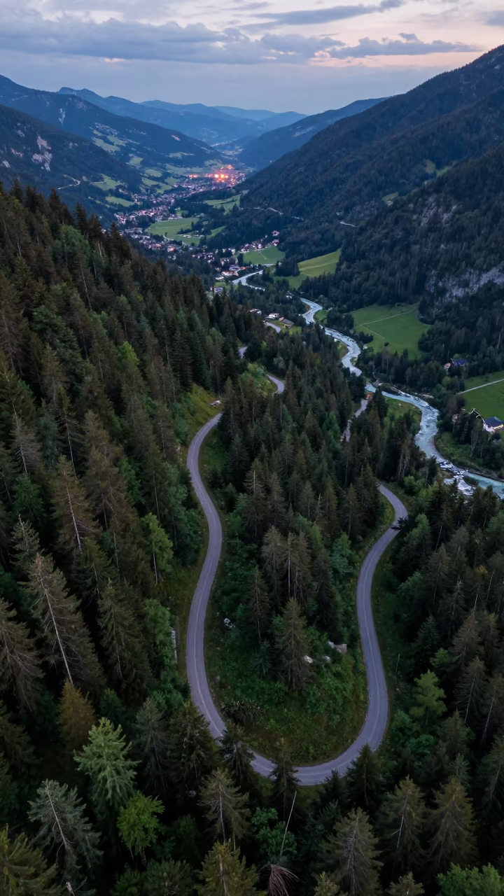 Aerial View of Mountain Trail Through Forest Tyrol in far above river meanders in Tyrol