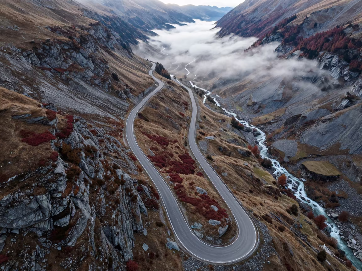 Aerial View of Swiss Mountain Switchback Road in high above braided river channels in Switzerland