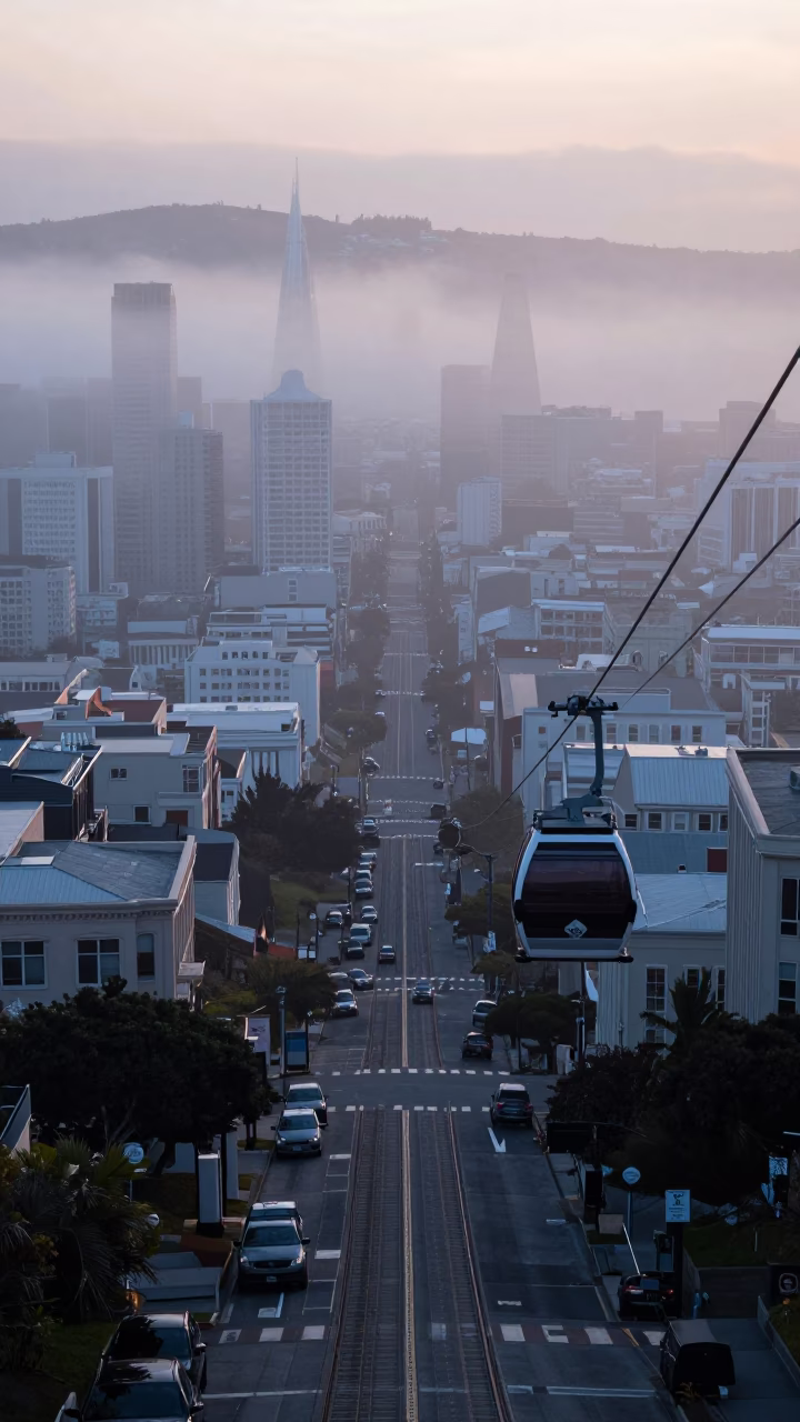 Aerial Tramway Gondola Drifting Through Morning Fog Above San Francisco Hills at Dawn in in San Francisco, California, United States