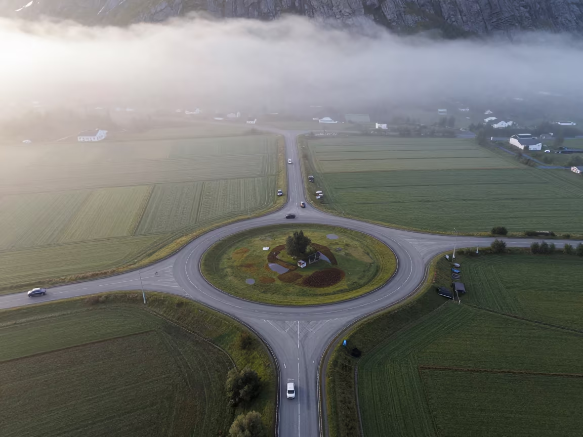 Aerial View of Norwegian Roundabout in Misty Dawn in high above irrigation geometry in the Fjords of Norway