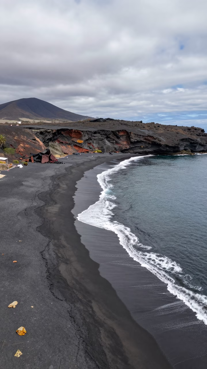 Aerial View of Volcanic Beach at La Paz in far above surf-scalloped coastline near La Paz