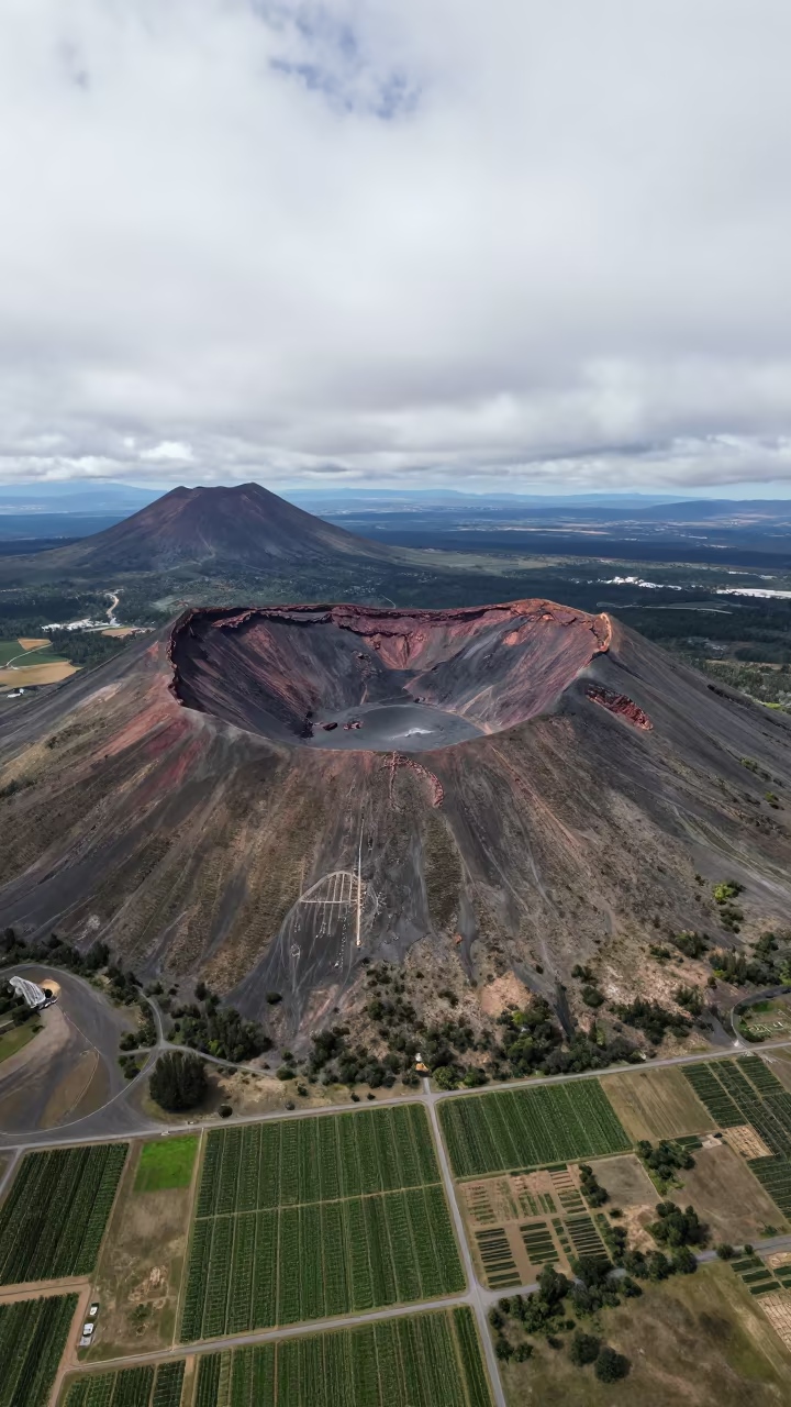 Aerial Volcanic Crater Chain Over Bolivian Orchards in far above orchard blocks and irrigation lines in Bolivia