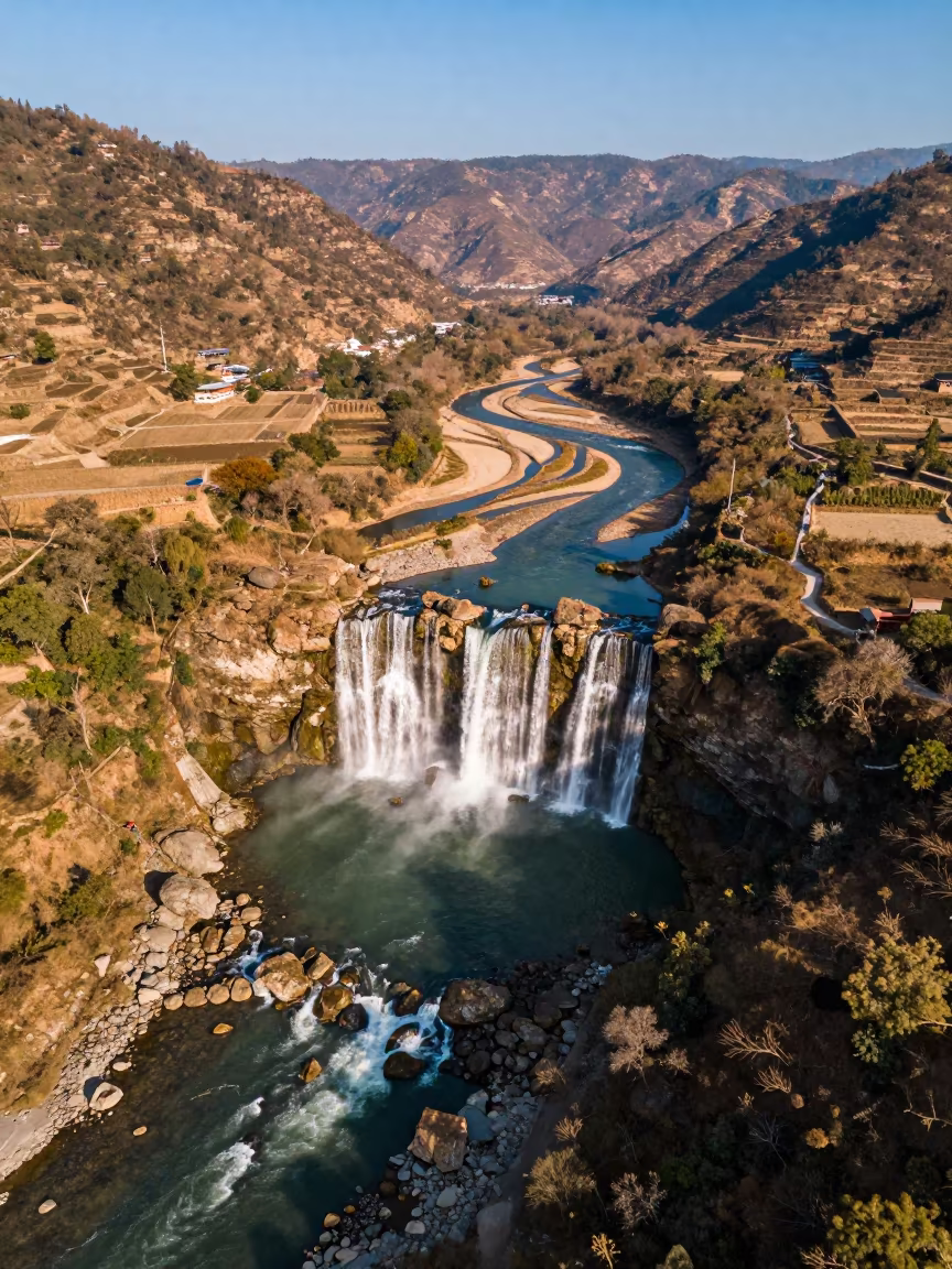 Aerial View Waterfall Round Pool Kathmandu in high above braided river channels near Boudhanath, Kathmandu
