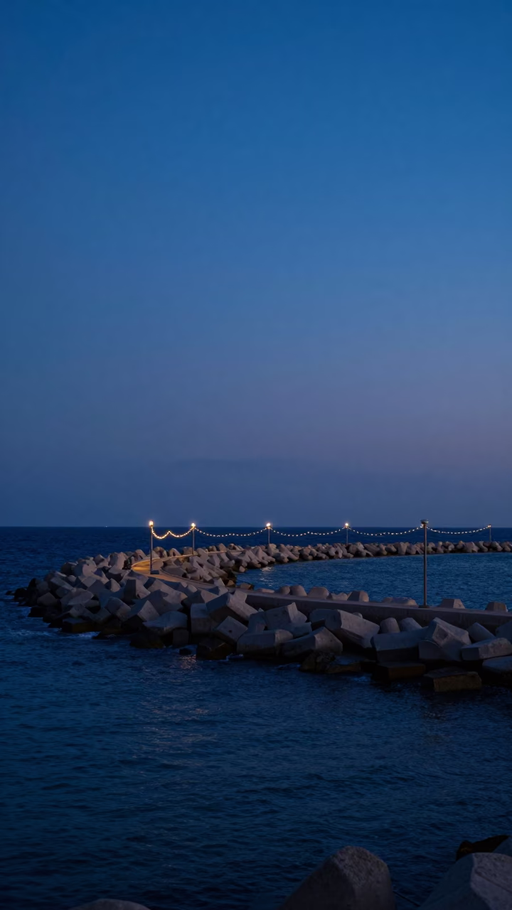 Alexandria Egypt Blue Hour Harbor Breakwater String Lights and Fading Sky in in Alexandria, Egypt