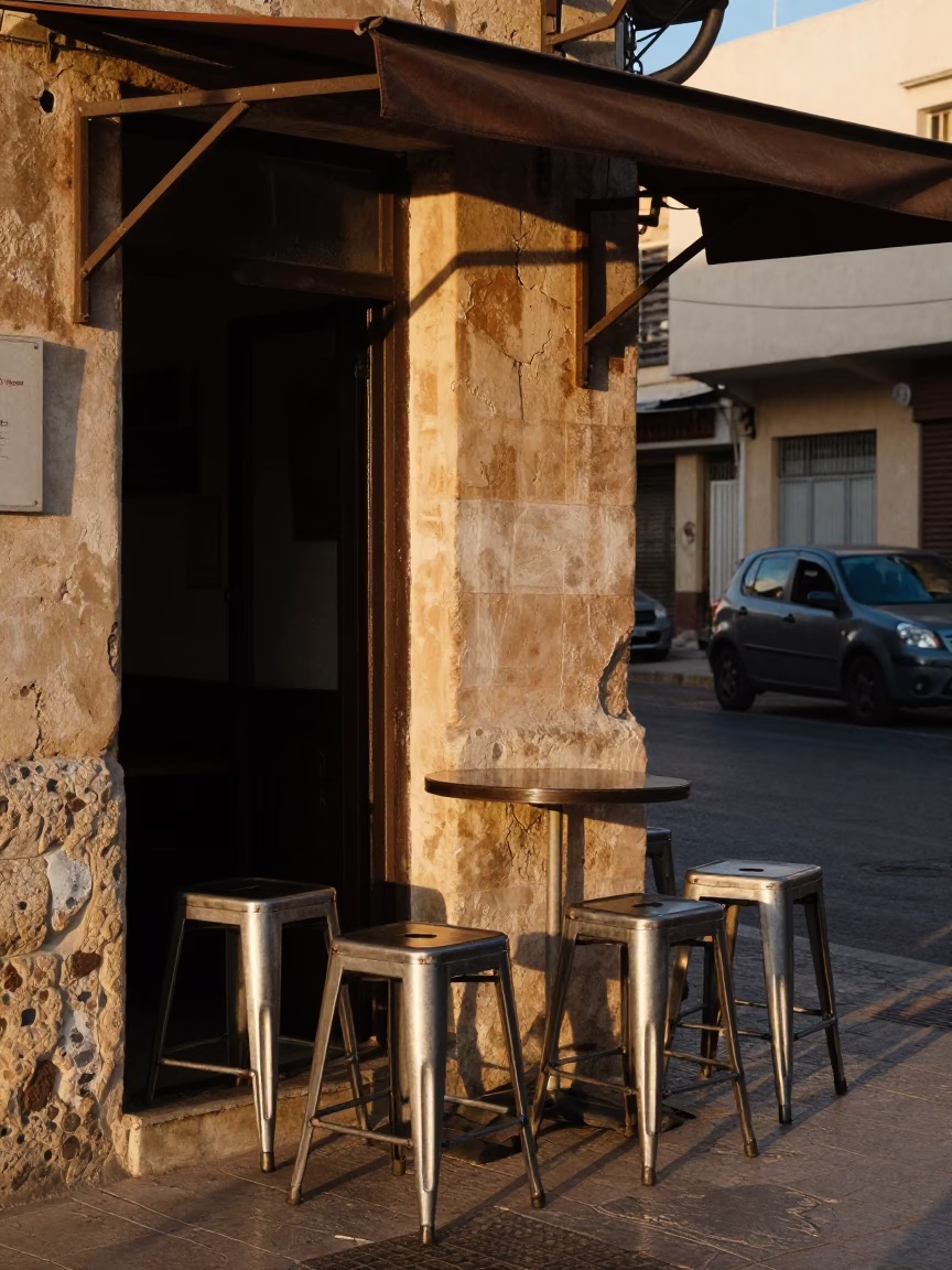 Alexandria Egypt Street Scene Late Afternoon Light with Metal Stools and Chalkboard in in Alexandria, Egypt
