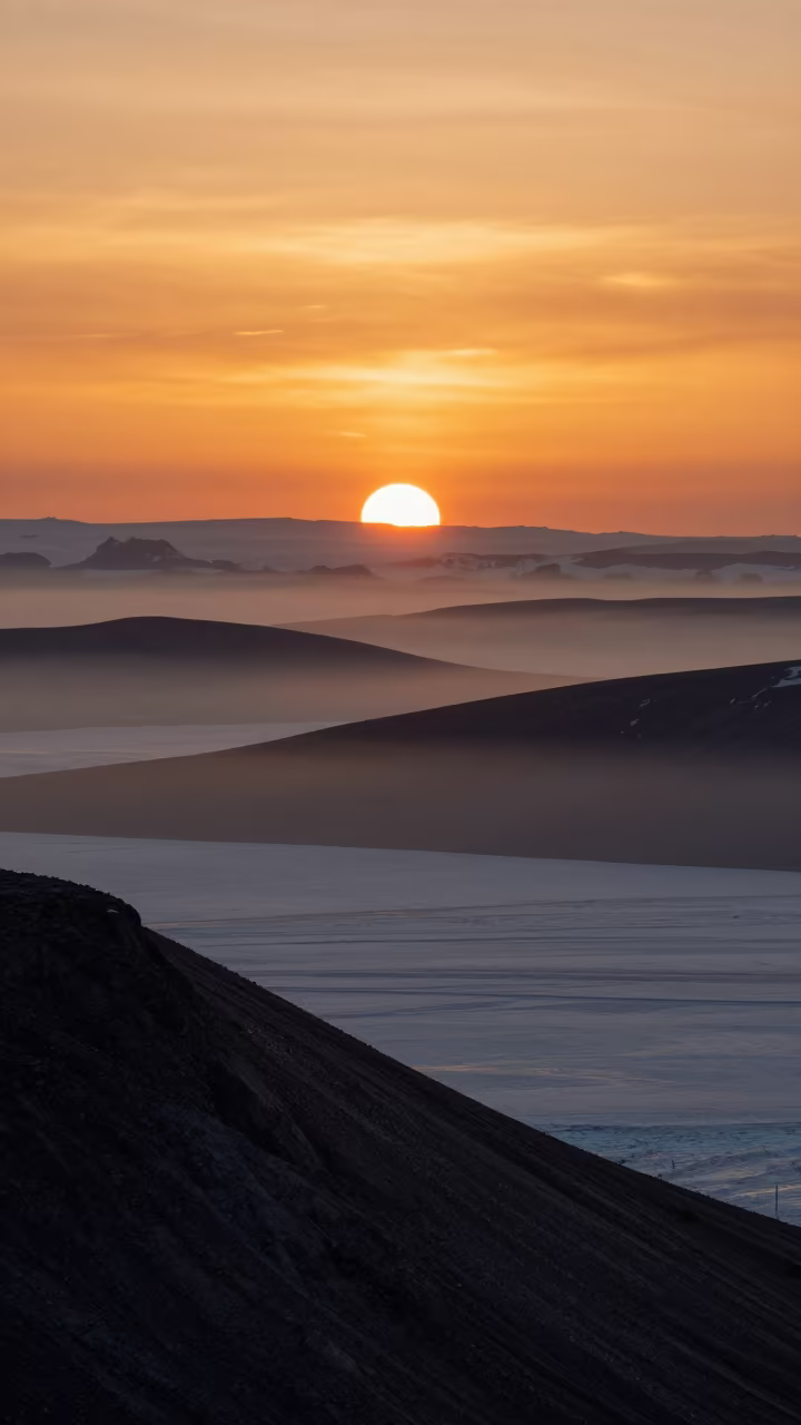 Amber Polar Sunset Over Layered Foothills and Mist in from a ridge above layered foothills near Sapporo