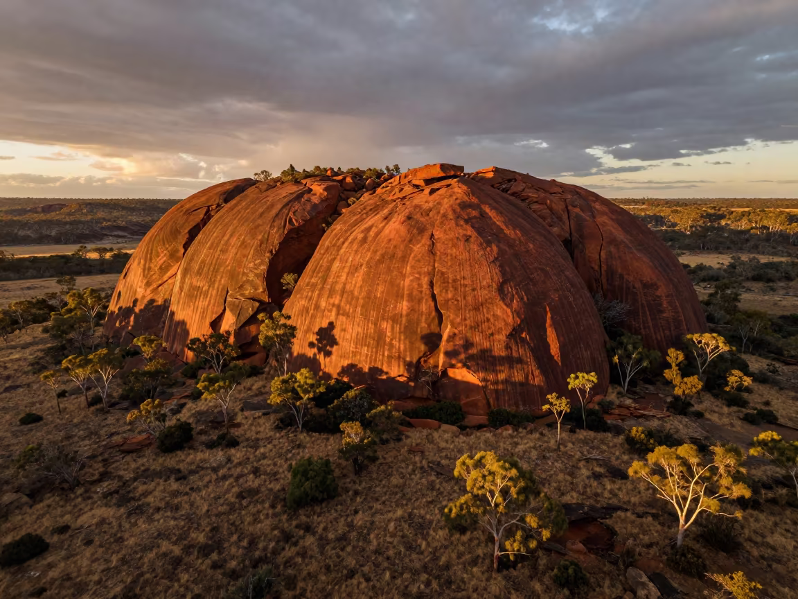 Amber Sunset Over Aboriginal Sacred Rock Valley in across a wide valley floor near Sydney