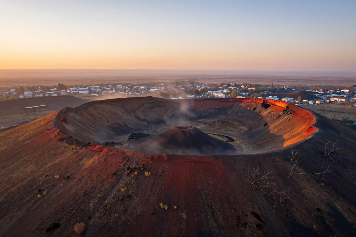 Amber Sunset Over Crater Chain Volcanic Plateau in high above patterned rooftops near Almaty