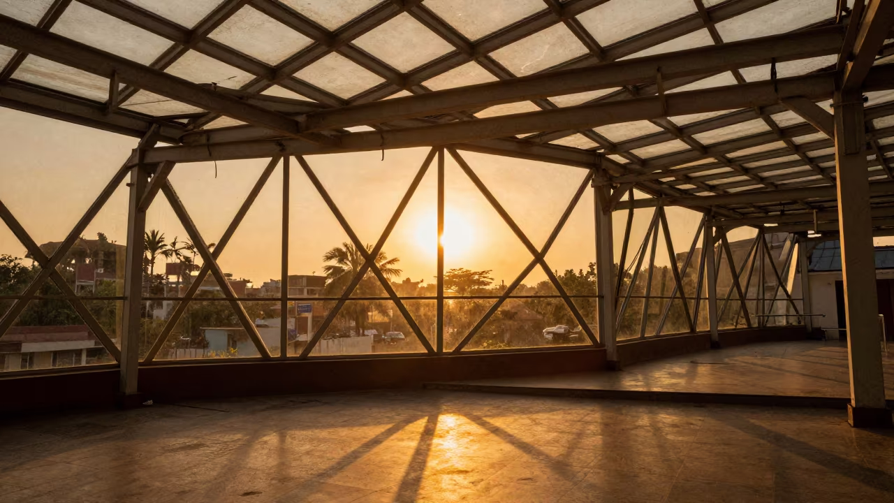 Amber Sunset Light on Triangular Glass Panels in inside a glass-roofed arcade near Prayagraj