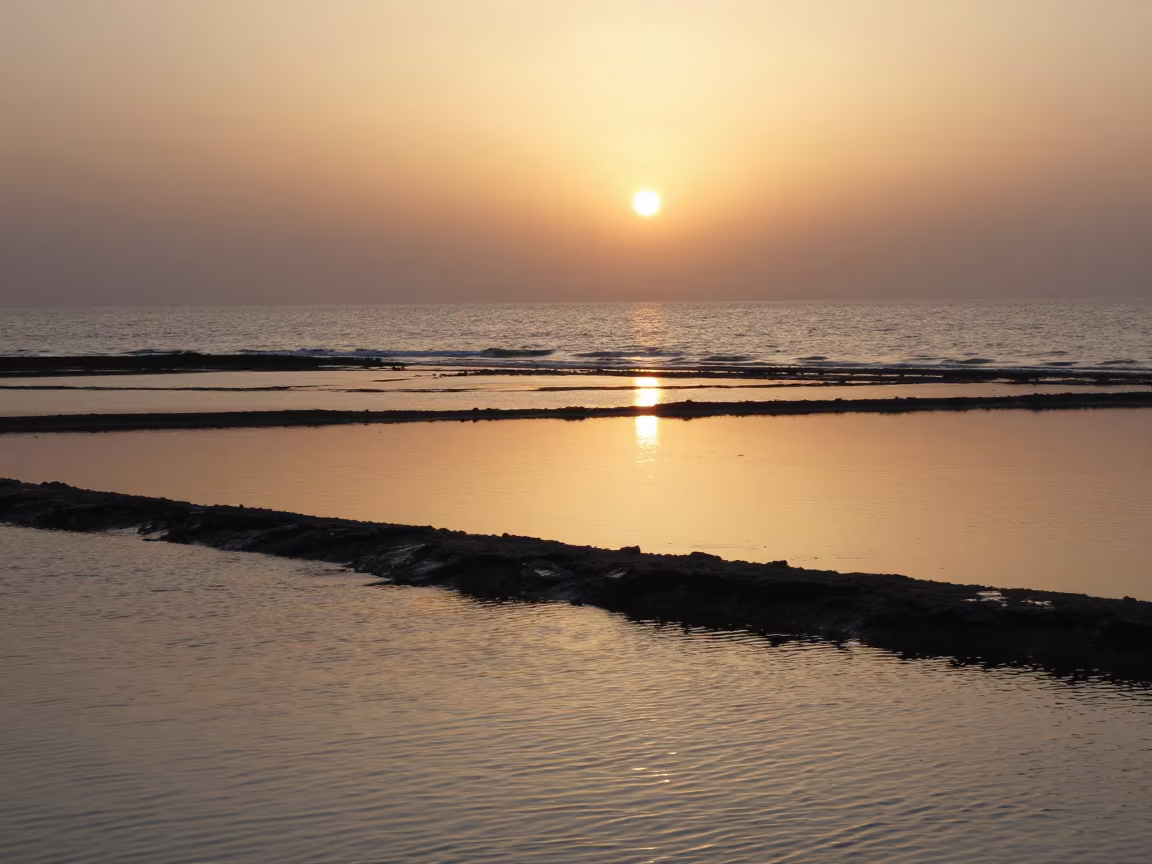 Amber Sunset Reflections on Wet Tidal Flats in along a wave-cut shoreline near Kahramanmaraş