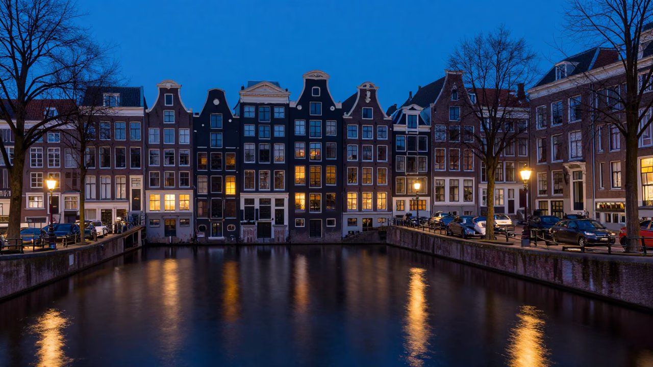 Amsterdam Blue Hour Canal View with Brick Architecture and Reflections in in Amsterdam, Netherlands
