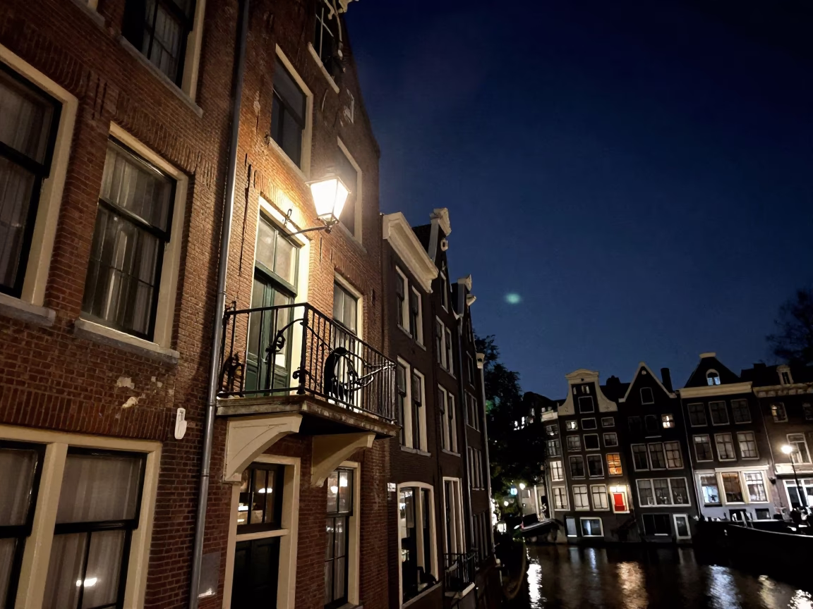 Amsterdam canal house balcony under deep night sky with pears and slippers in in Amsterdam, Netherlands
