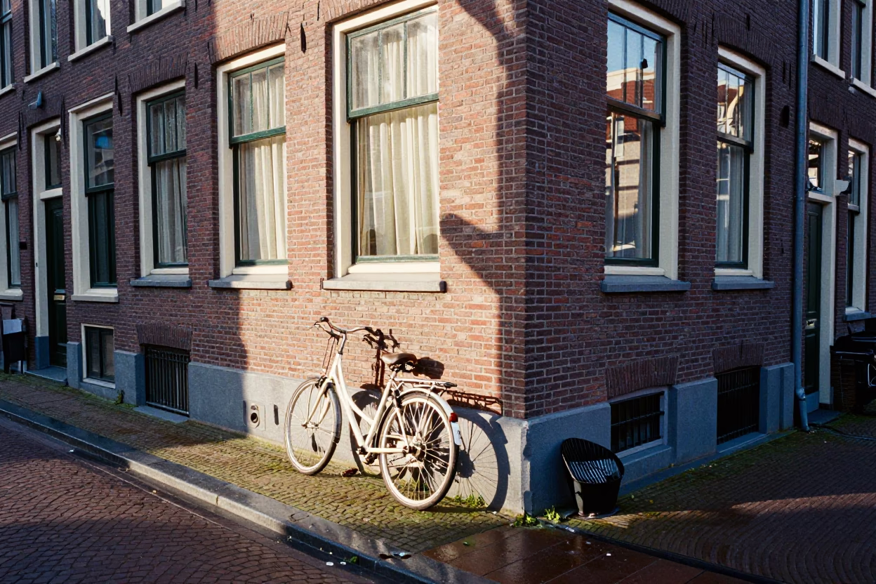 Amsterdam Canal House Brickwork and Cobblestone Street Corner Late Morning Light in in Amsterdam, Netherlands