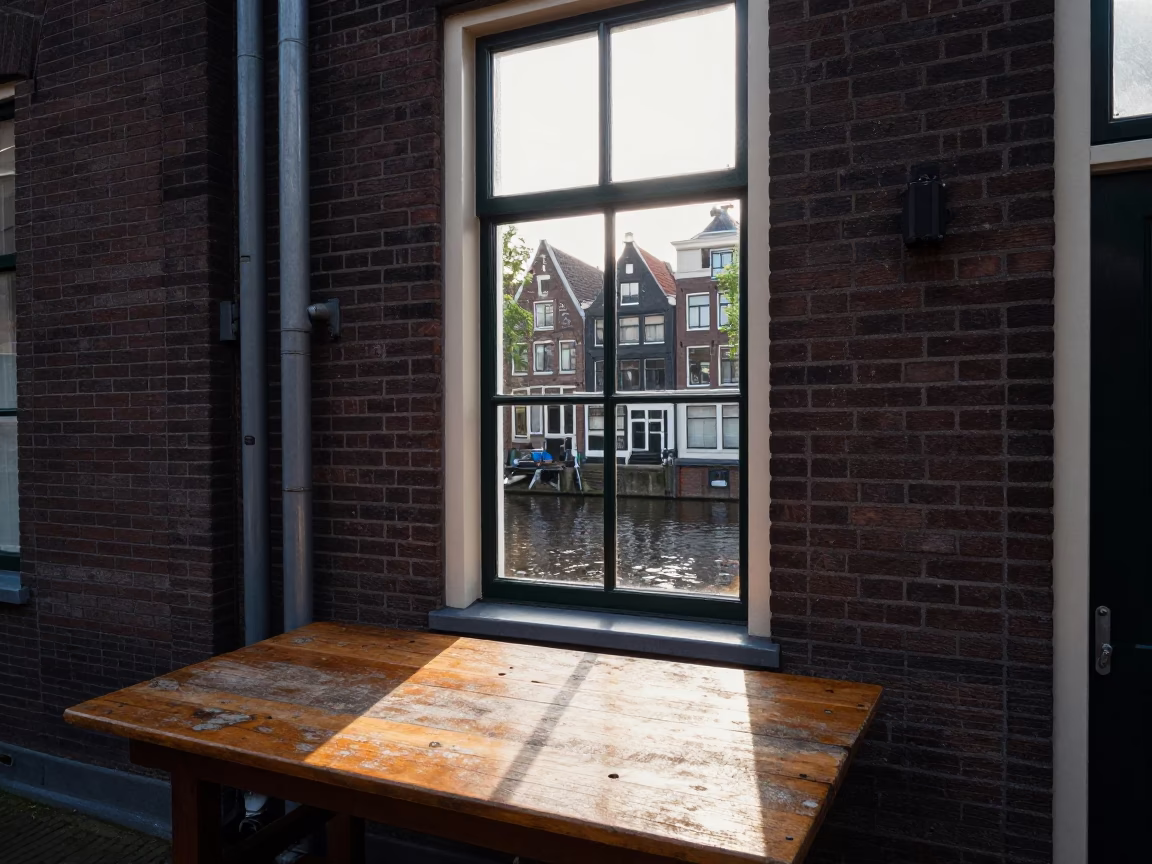 Amsterdam Canal House District Heating Pipes and Window Light in Late Afternoon in in Amsterdam, Netherlands
