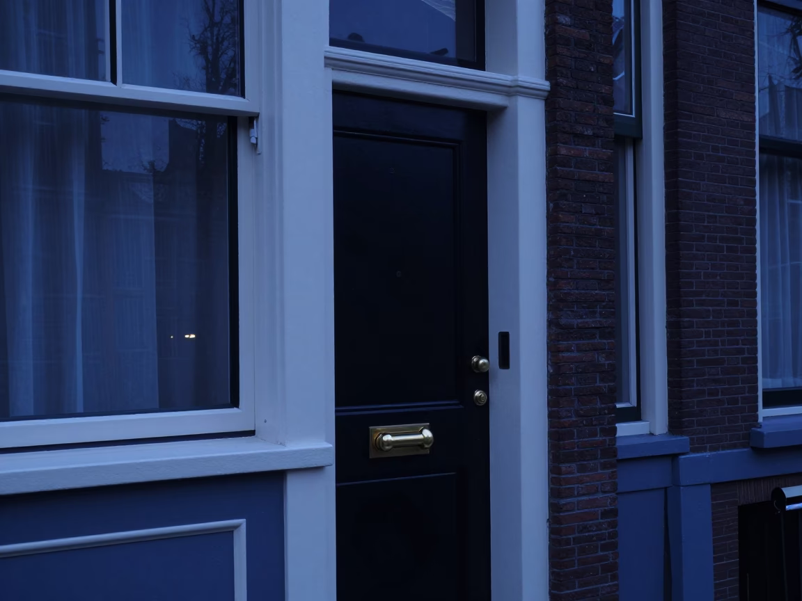 Amsterdam canal house entrance at twilight with brass doorknob and ceramic key bowl in in Amsterdam, Netherlands