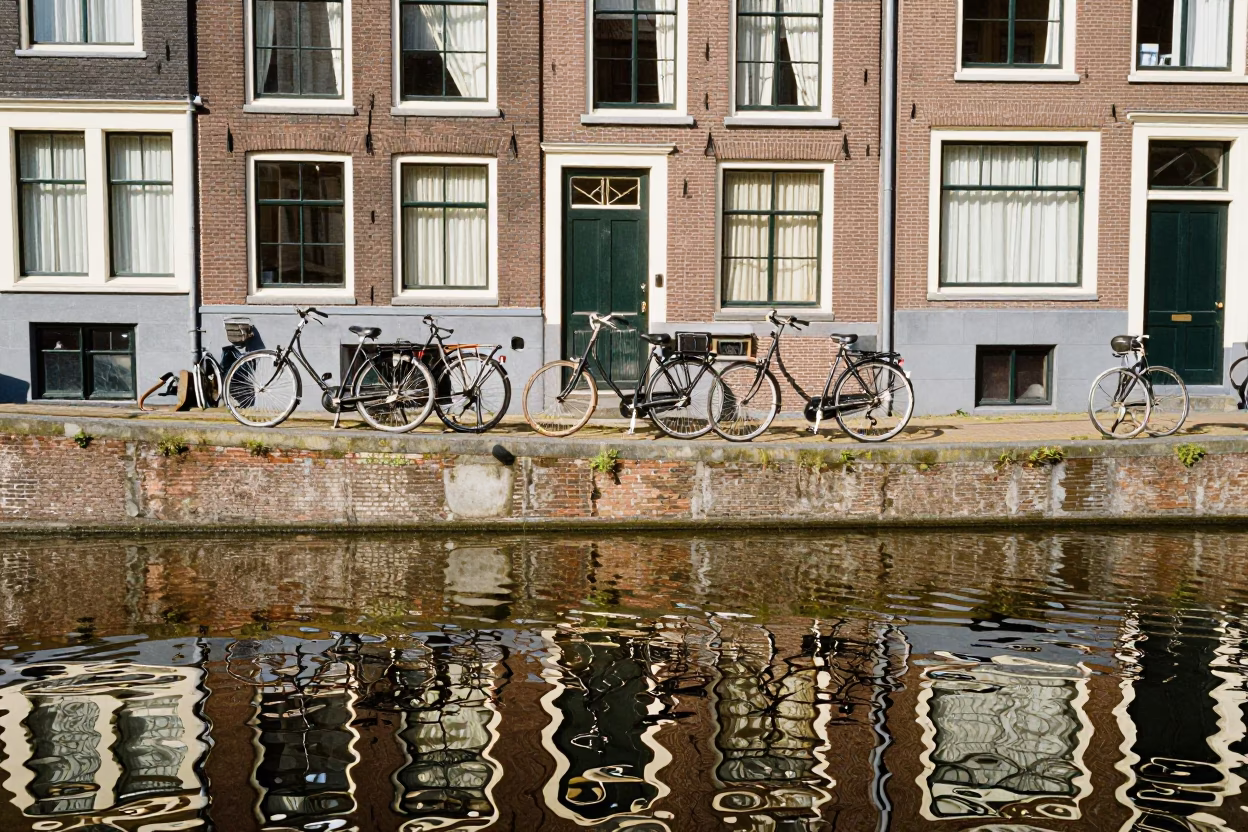 Amsterdam Canal House Facade and Bicycle Reflections at Midday in in Amsterdam, Netherlands