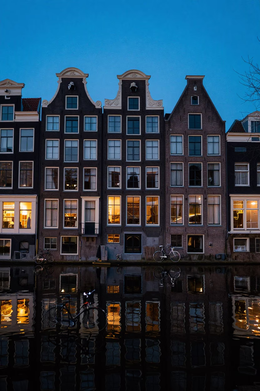 Amsterdam Canal House Facade at Blue Hour with Bicycle Reflections in in Amsterdam, Netherlands