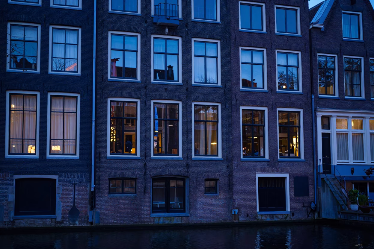 Amsterdam Canal House Facade in Evening Blue Light with Bicycle and Wicker Basket in in Amsterdam, Netherlands
