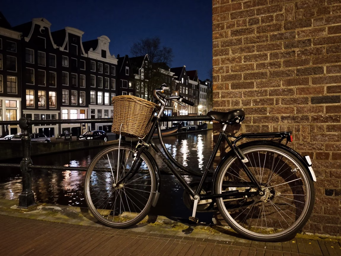 Amsterdam Canal House Night Street Scene with Vintage Bicycle and Wet Cobblestones in in Amsterdam, Netherlands
