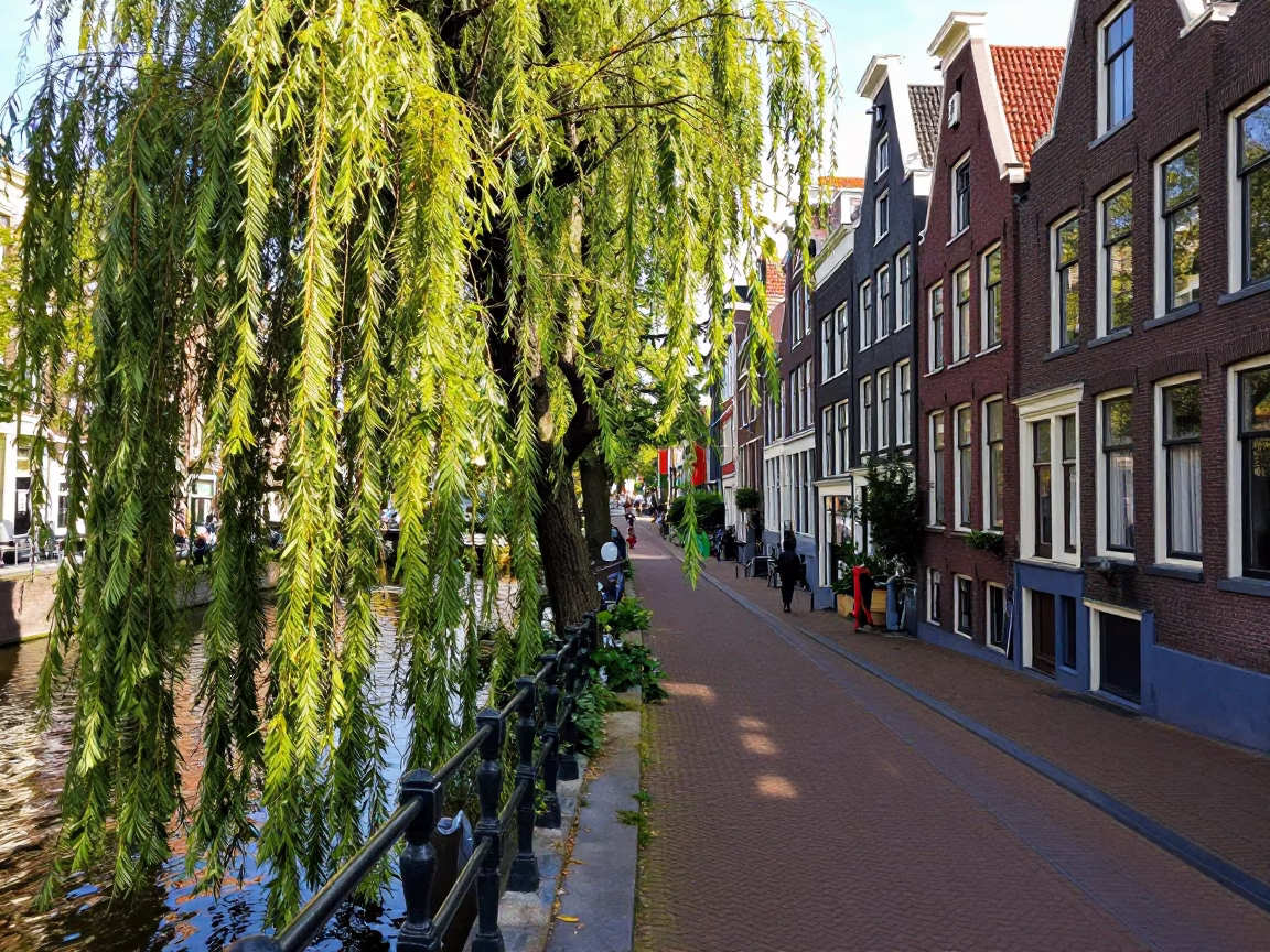 Amsterdam Canal Path with Weeping Willow and Colorful 1980s Fashion in in Amsterdam, Netherlands