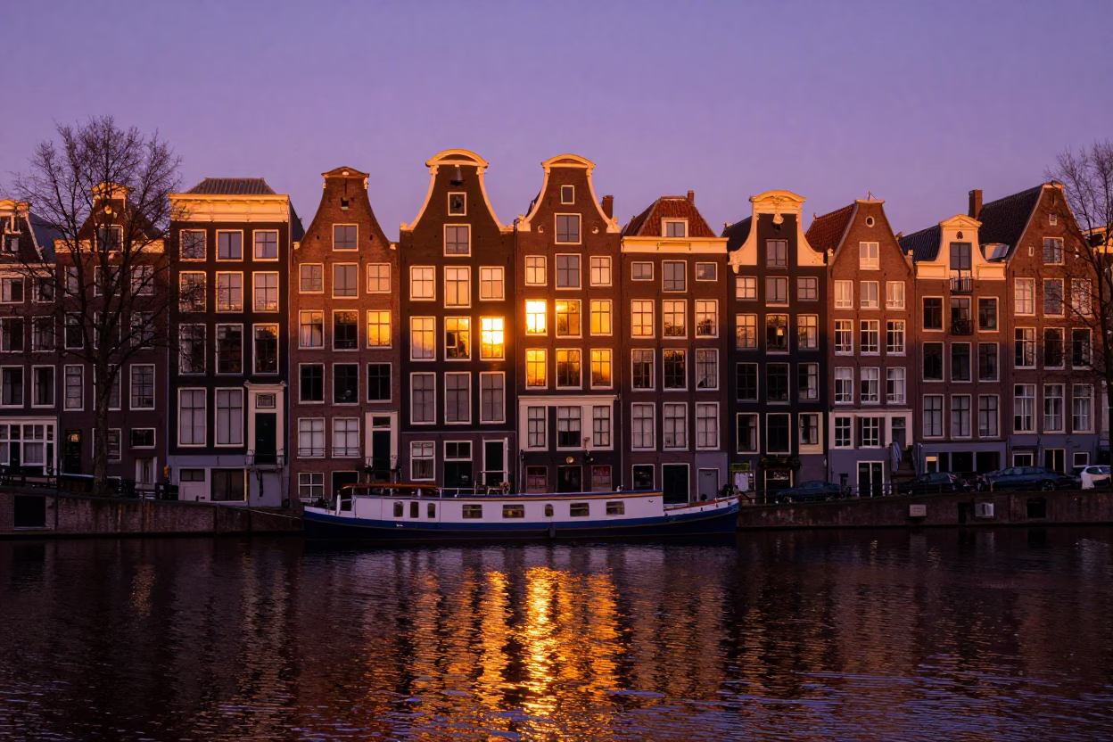 Amsterdam Canal Sunset View with Historic Gabled Houses and Reflections in Golden Light in in Amsterdam, Netherlands