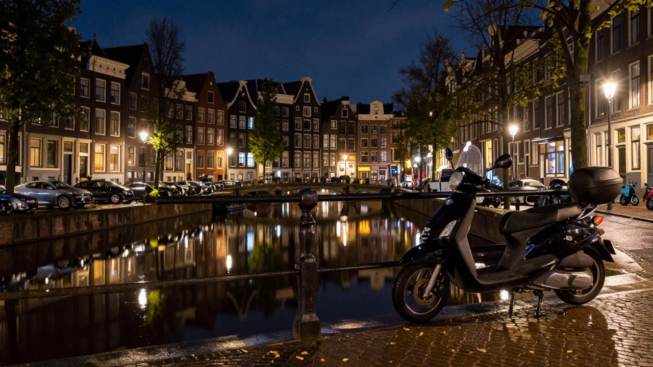 Amsterdam Night Canal Reflections and Scooter Parking Near Historic Brick Architecture in in Amsterdam, Netherlands
