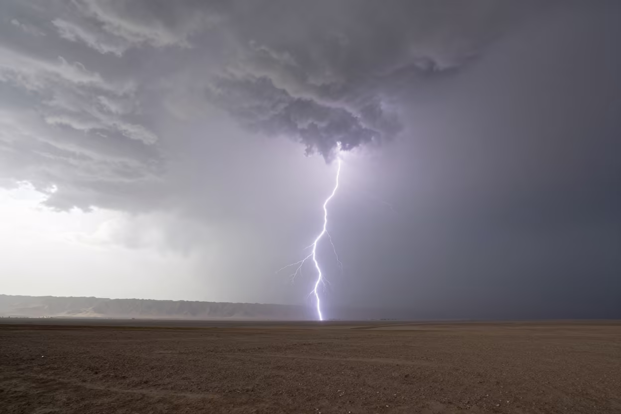 Anvil Cloud Lightning Over Afghan Storm Plain in across a storm-bright plain in Afghanistan
