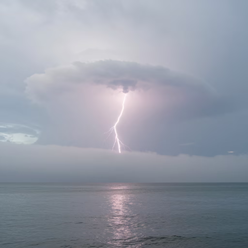 Anvil Cloud Lightning in Queensland Fog in through low marine fog in Queensland