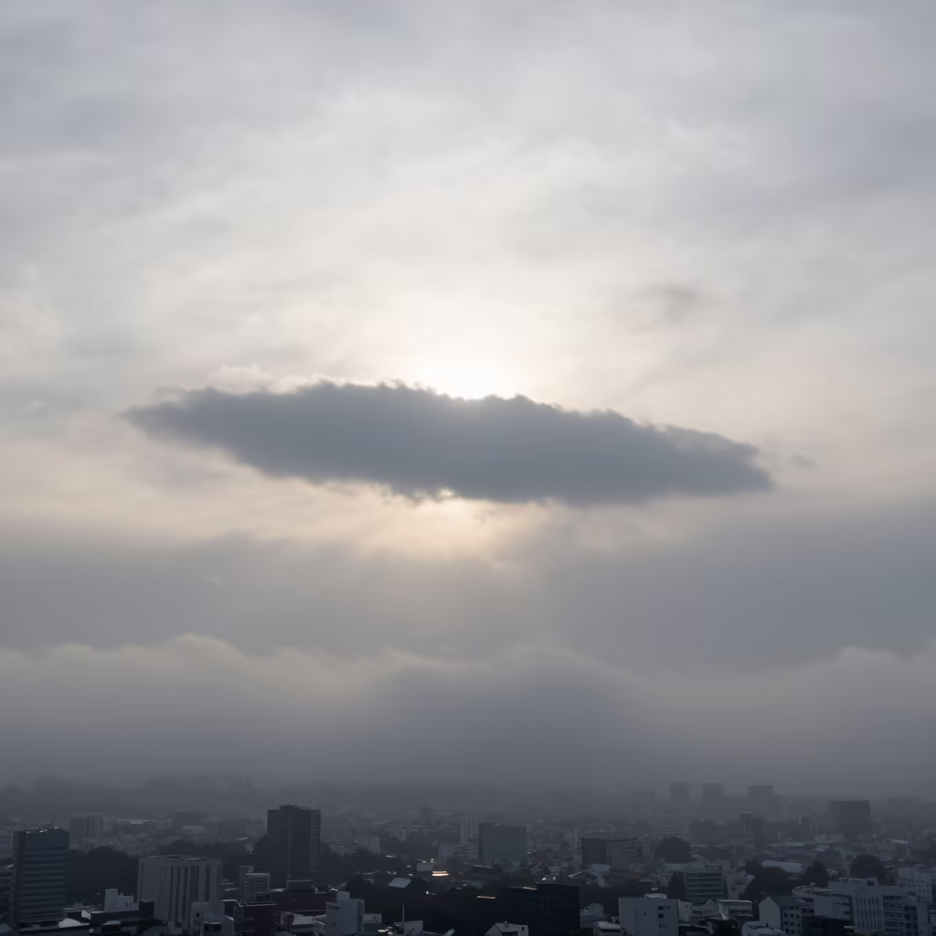 Anvil Cloud Silhouette Over Tokyo Fog in through low marine fog near Tokyo