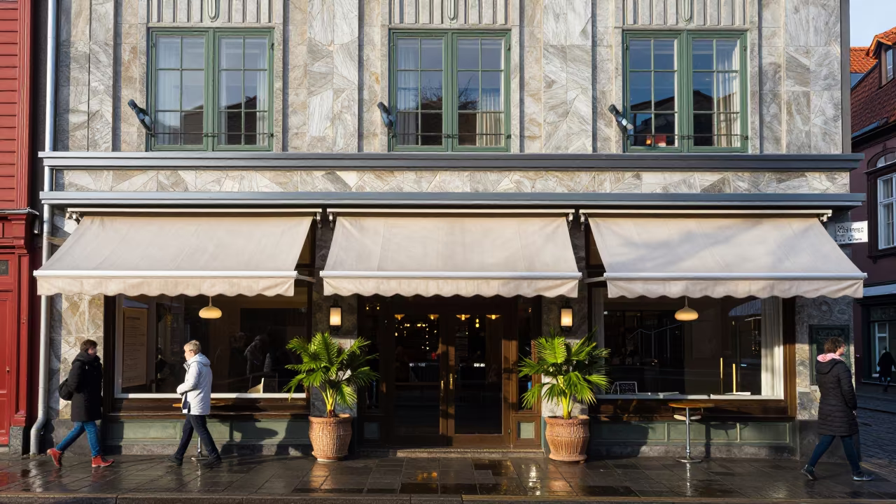 Art Deco Hotel Facade in Bergen Polar Night in beneath hotel awnings at the curb in Fish Market, Bergen